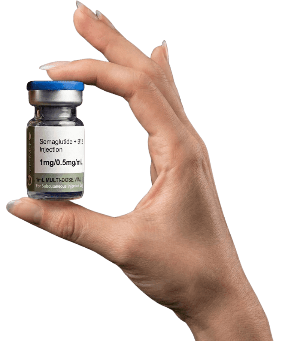 A hand holding a vial of compounded medication